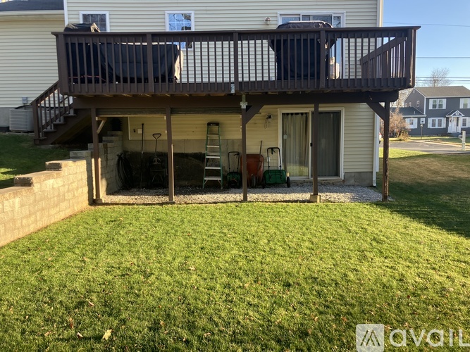 A house with a deck and a lawn.