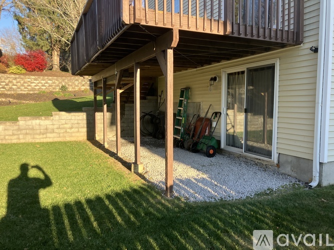 A house with a wooden porch and a shadow of a person.