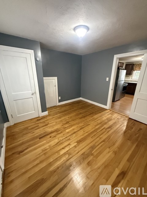 A room with wooden flooring and white doors.