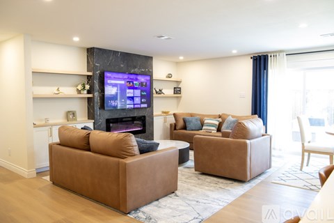 A living room with a fireplace and a television.