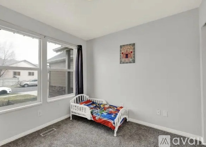 A baby's room with a crib and a window.