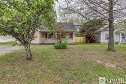 A house with a tree in front of it.