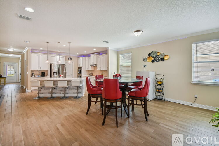 A dining room with a table set for four.