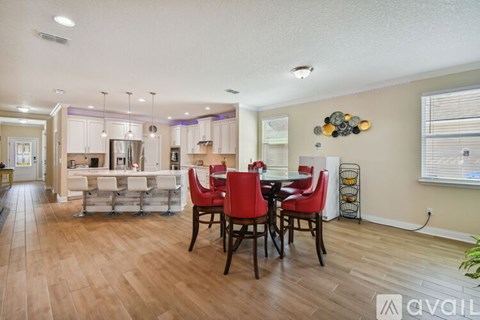 A dining room with a table set for four.