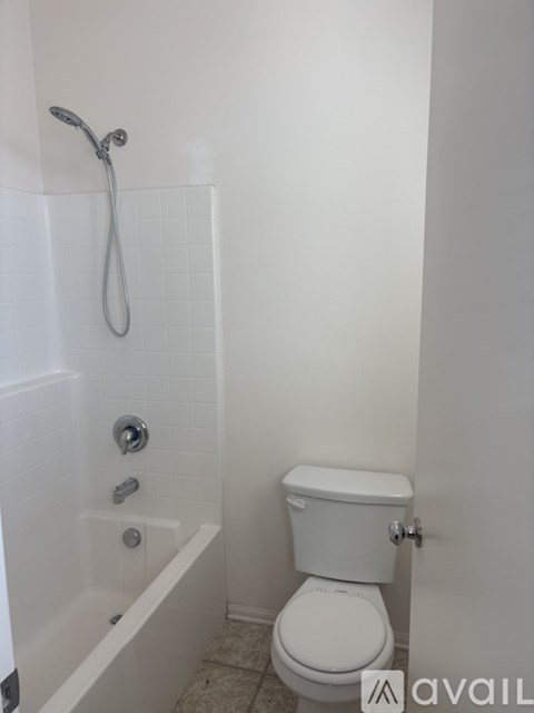 A white toilet is next to a white bathtub in a bathroom.