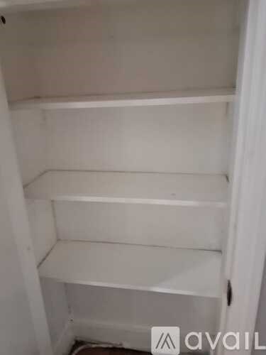 A white shelving unit with three shelves is shown.