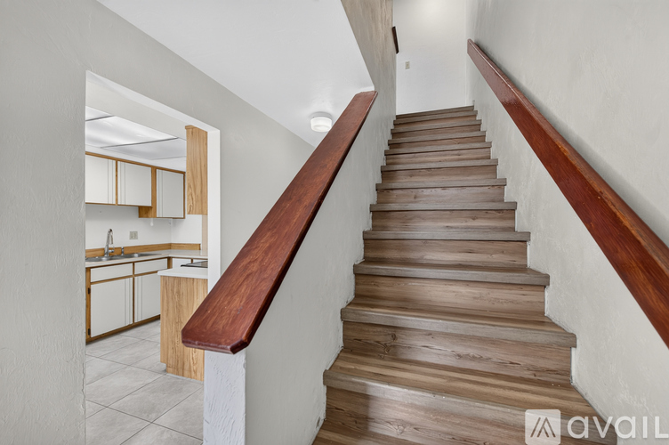 A staircase with wooden steps and a wooden handrail.