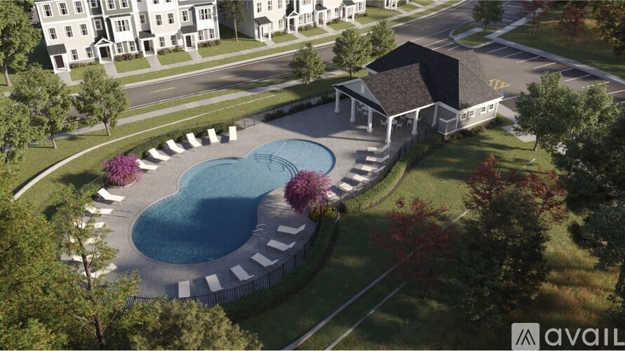 A bird's eye view of a swimming pool surrounded by a white fence.