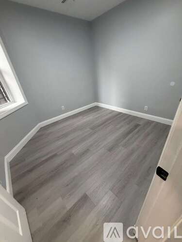 A room with grey walls and wooden flooring.