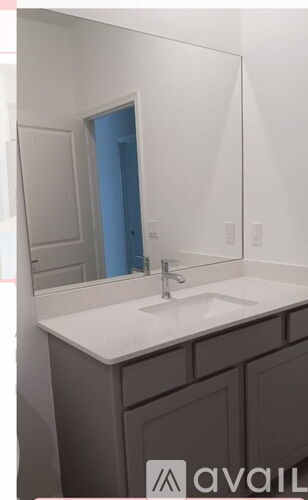 A bathroom with a sink and a mirror.