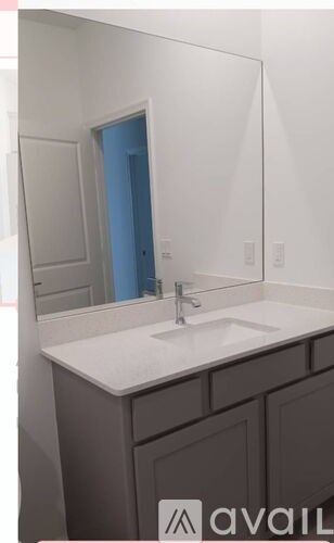 A bathroom with a sink and a mirror.