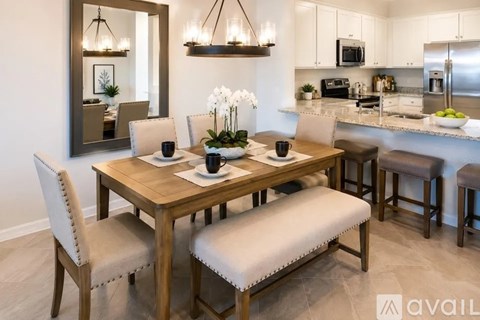 A dining room with a wooden table set for four.