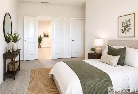A bedroom with a large bed and a mirror on the wall.