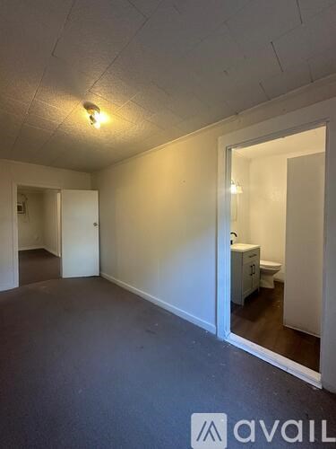 A room with a carpeted floor and a mirror on the wall.