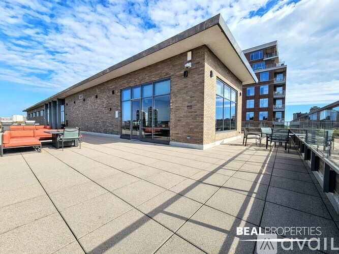 A modern building with a flat roof and large windows is showcased in the image.