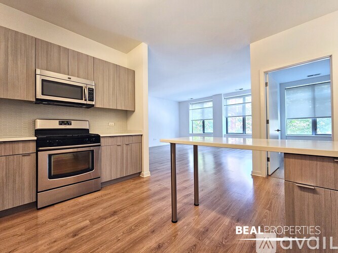 A kitchen with a stove top oven and microwave above it.