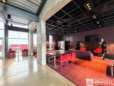 A large open space with a dining area and a bar.