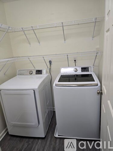 Two front loading washing machines in a laundry room.