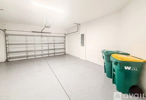 A storage room with a metal shelving unit and two green bins.