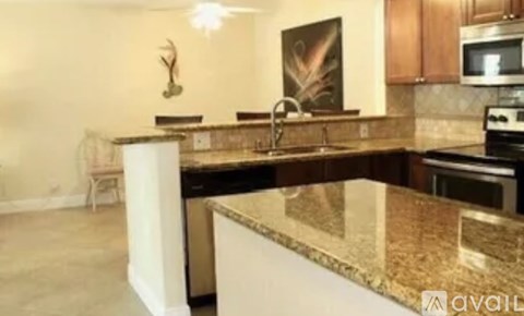 A kitchen with granite countertops and a microwave above the stove.