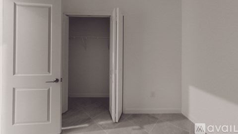 A room with a door and a wall with a hanger.