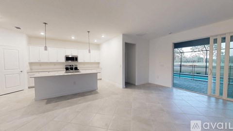 A spacious room with a white counter and a balcony with a glass railing.