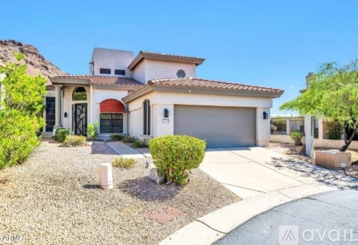 A house with a red awning is for sale.