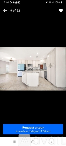 A modern kitchen with a blue island in the middle.