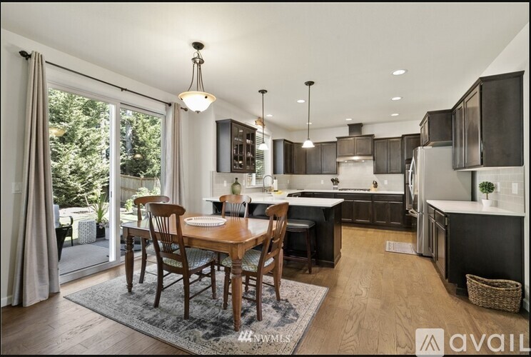 A modern kitchen with a dining table set up.