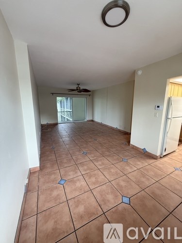 A room with tiled flooring and a ceiling fan.