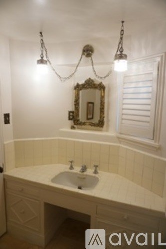 A bathroom with a sink and a mirror.