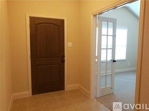 A room with a brown door and a white door.