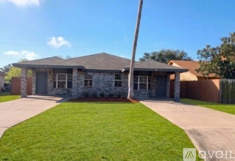 A house with a stone facade is available for sale.