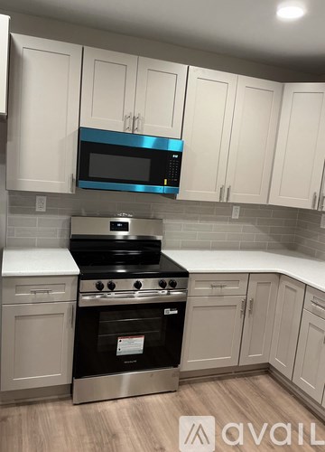 A kitchen with a stove top oven and microwave above it.