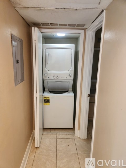 A white washing machine is in a small room.