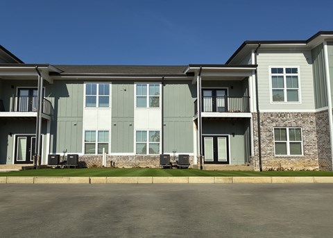 A large two-story building with a balcony on the second floor.