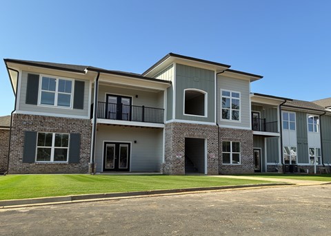 A row of townhouses with balconies and garages.