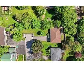 A bird's eye view of a residential area with houses and trees.