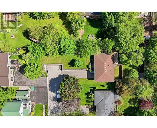 A bird's eye view of a residential area with houses and trees.