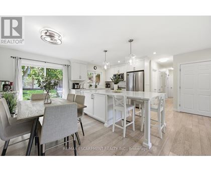 A white kitchen with a table and chairs.