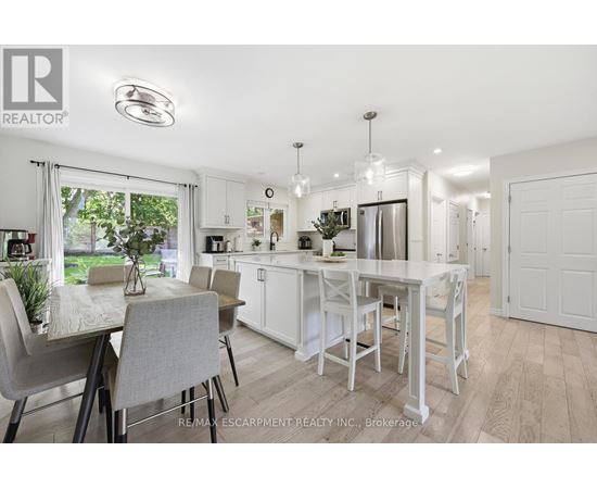 A white kitchen with a table and chairs.