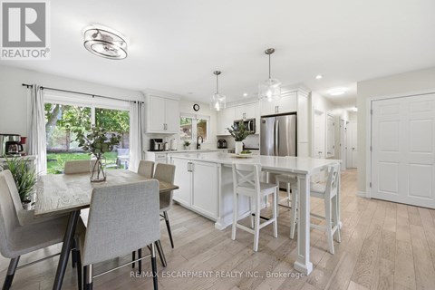 A white kitchen with a table and chairs.