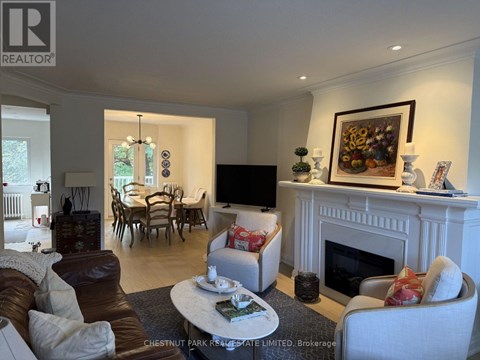 A living room with a fireplace and a painting on the wall.