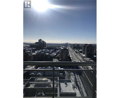 A sunny day in a city with a view of the highway and buildings.
