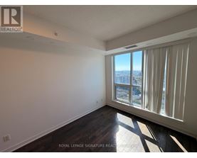 A room with a large window overlooking a cityscape.