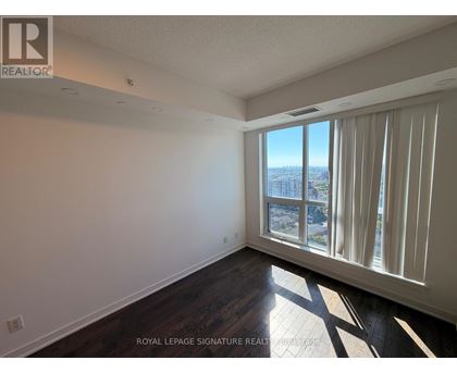 A room with a large window overlooking a cityscape.
