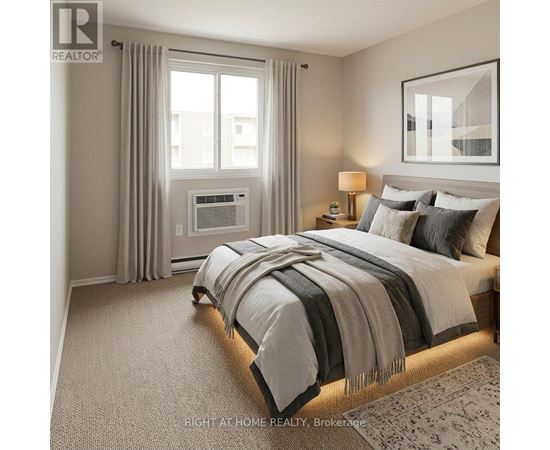 A well-lit bedroom with a large bed and a window with curtains.