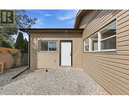 A house with a white door and a window is for sale.