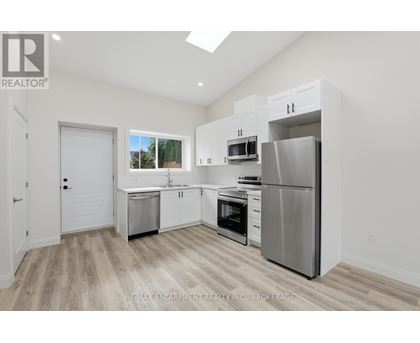 A kitchen with white cabinets and stainless steel appliances.