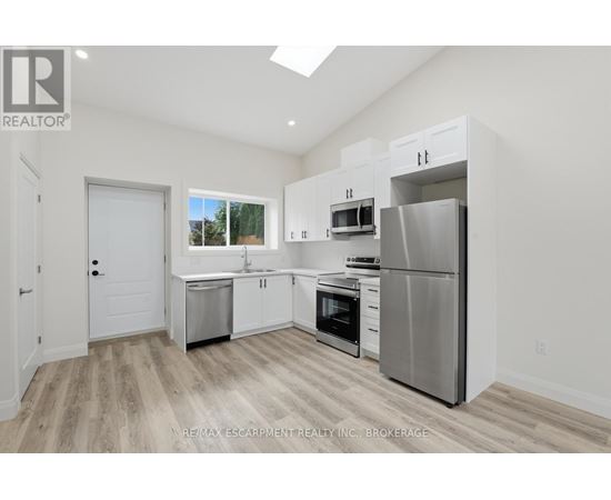 A kitchen with white cabinets and stainless steel appliances.